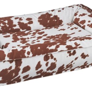 Brown and white cow-print sofa with plush cushions, shown from an angled perspective