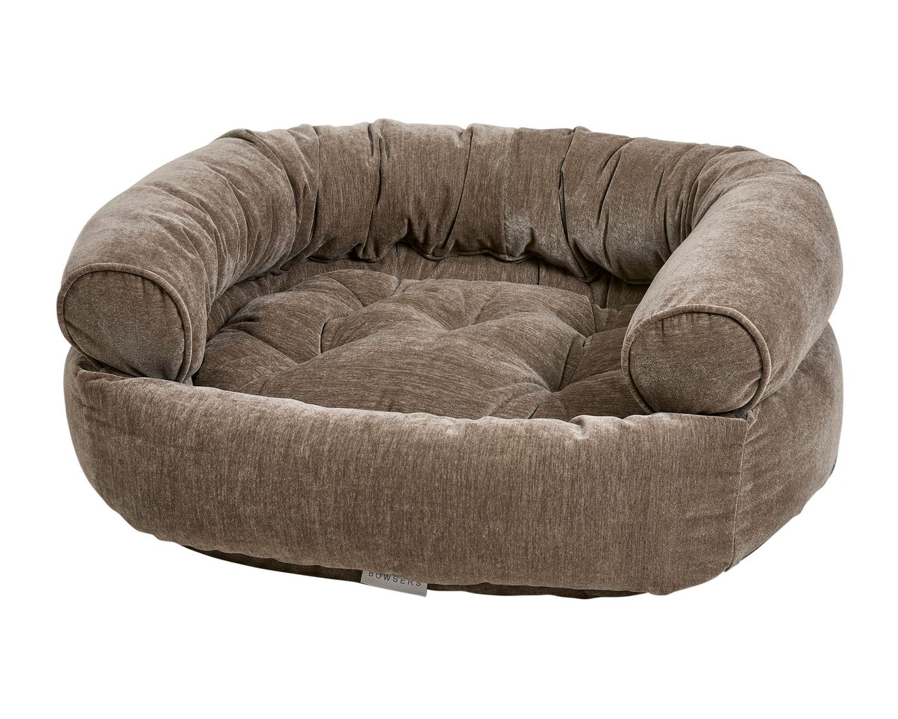Round plush pet bed with raised, cushioned armrests and tufted inner cushion in brown tones.