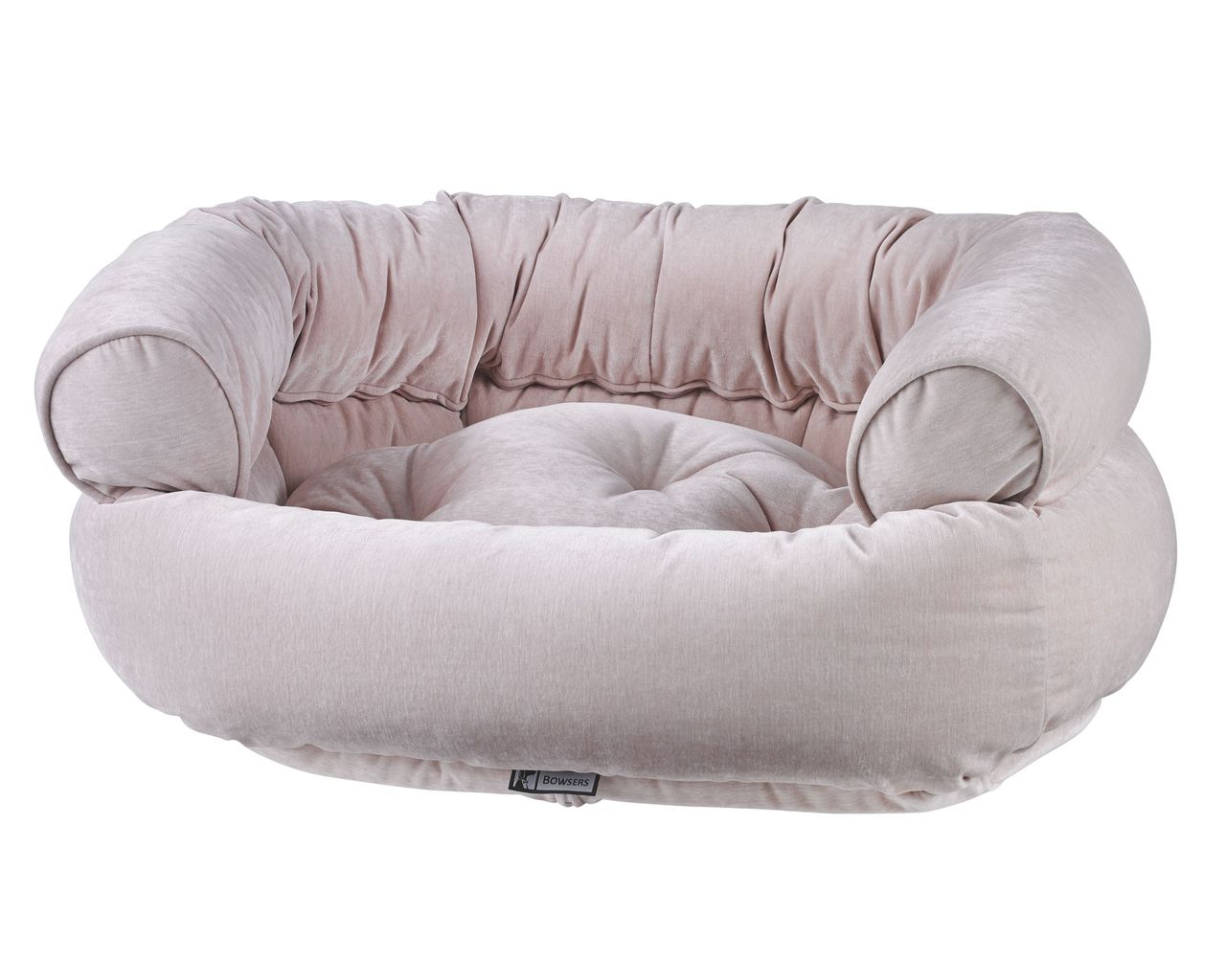 Soft blush pink round pet bed with plush cushioned sides and sunken center.','Circular plush dog bed with thick rolled arms and tufted center in light pink.','Cozy round pet bed for small animals or dogs, soft velvet-like fabric, pale pink.