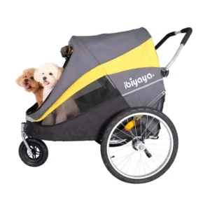Pet bicycle trailer/stroller in gray with a yellow stripe, two small dogs peeking out from the front opening.